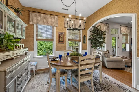 a kitchen with stainless steel appliances granite countertop a refrigerator a stove and a sink with wooden floor