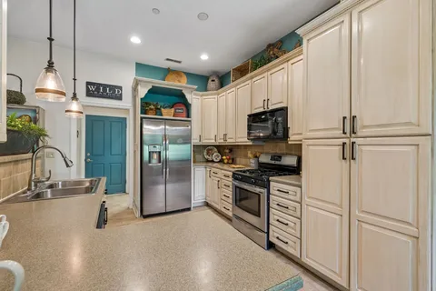 a kitchen with a sink stove and cabinets