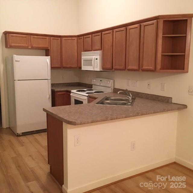 914 D Brawley School Road, Unit D Mooresville, NC 28117 - Photo 12 of 13 a kitchen with a sink and a refrigerator