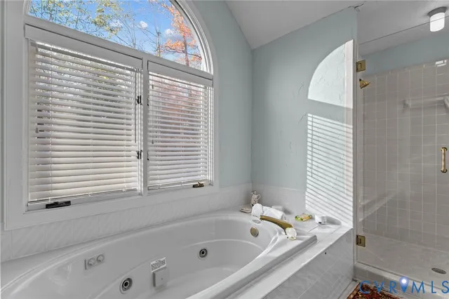 a bathroom with a bathtub and shower