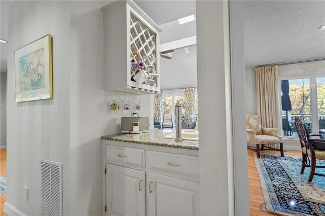 a en suite bathroom with a granite countertop sink and a mirror