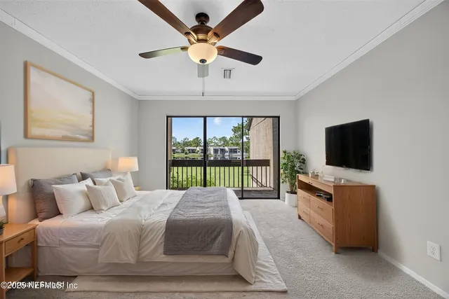 a spacious bedroom with a bed and a flat screen tv