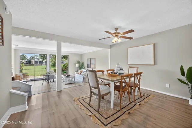 a view of a dining room with furniture window and wooden floor