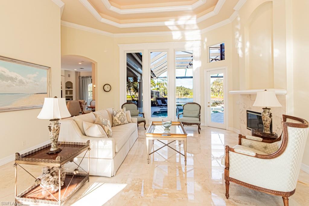 1676 Persimmon Drive Naples, FL 34109 - Photo 12 of 50 a living room with furniture a table and white walls