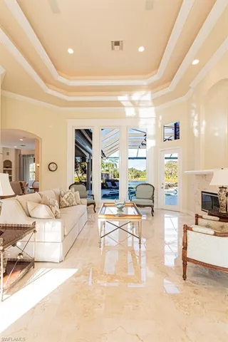 a living room with fireplace furniture and a large window
