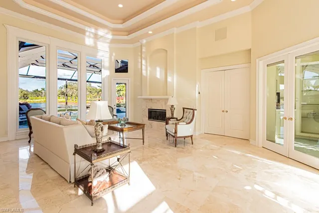 a living room with furniture a dining table and a large window