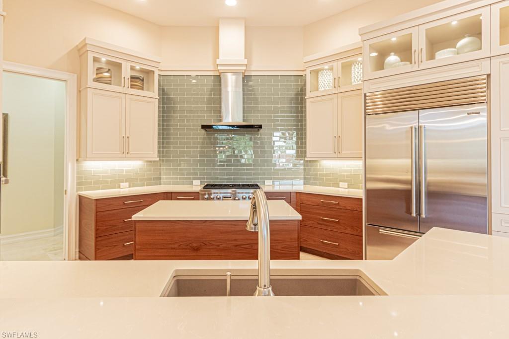 1676 Persimmon Drive Naples, FL 34109 - Photo 18 of 50 a bathroom with a tub sink and mirror