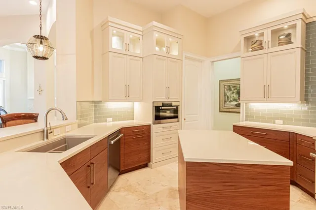 a kitchen with stainless steel appliances granite countertop a sink dishwasher stove and refrigerator