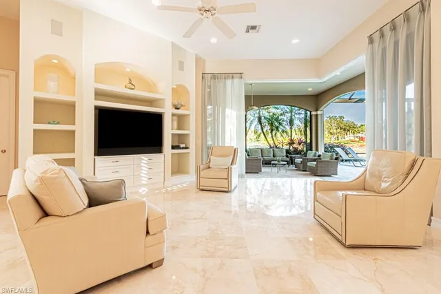 a living room with furniture fireplace and flat screen tv