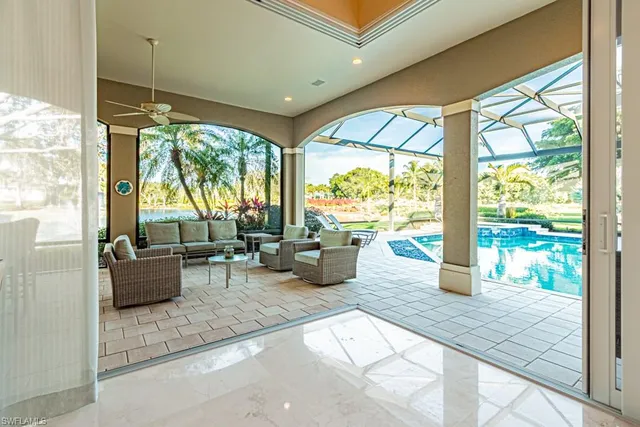 a living room with furniture and floor to ceiling windows