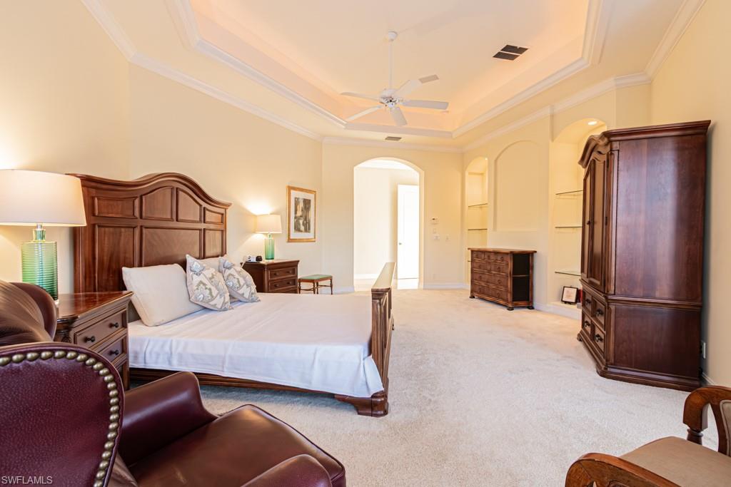 1676 Persimmon Drive Naples, FL 34109 - Photo 26 of 50 a bedroom with furniture and a fireplace