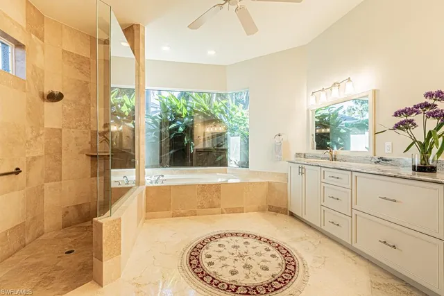 a spacious bathroom with a tub and window