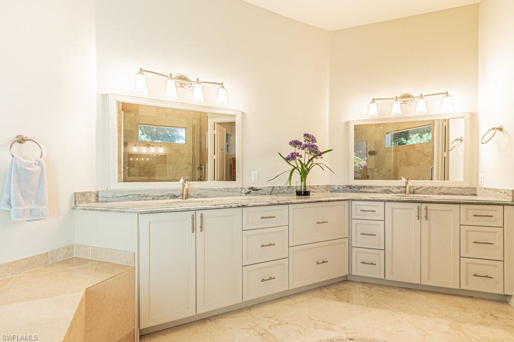 1676 Persimmon Drive Naples, FL 34109 - Photo 29 of 50 a bathroom with a granite countertop sink and a mirror