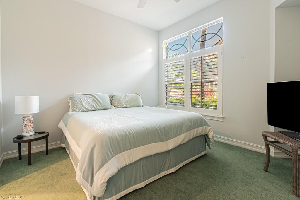 1676 Persimmon Drive Naples, FL 34109 - Photo 32 of 50 a bedroom with a bed tv and a window