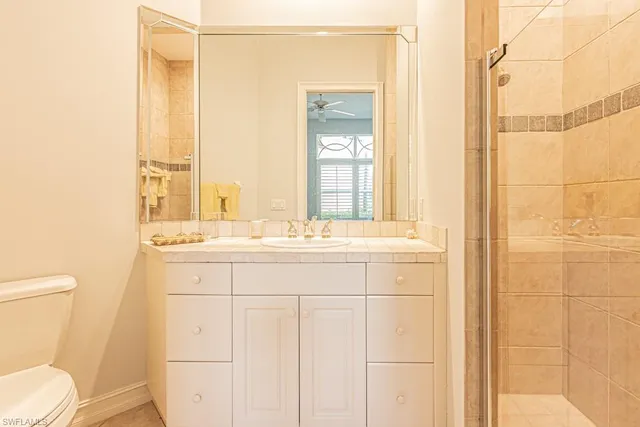 a bathroom with a sink and a mirror with toilet