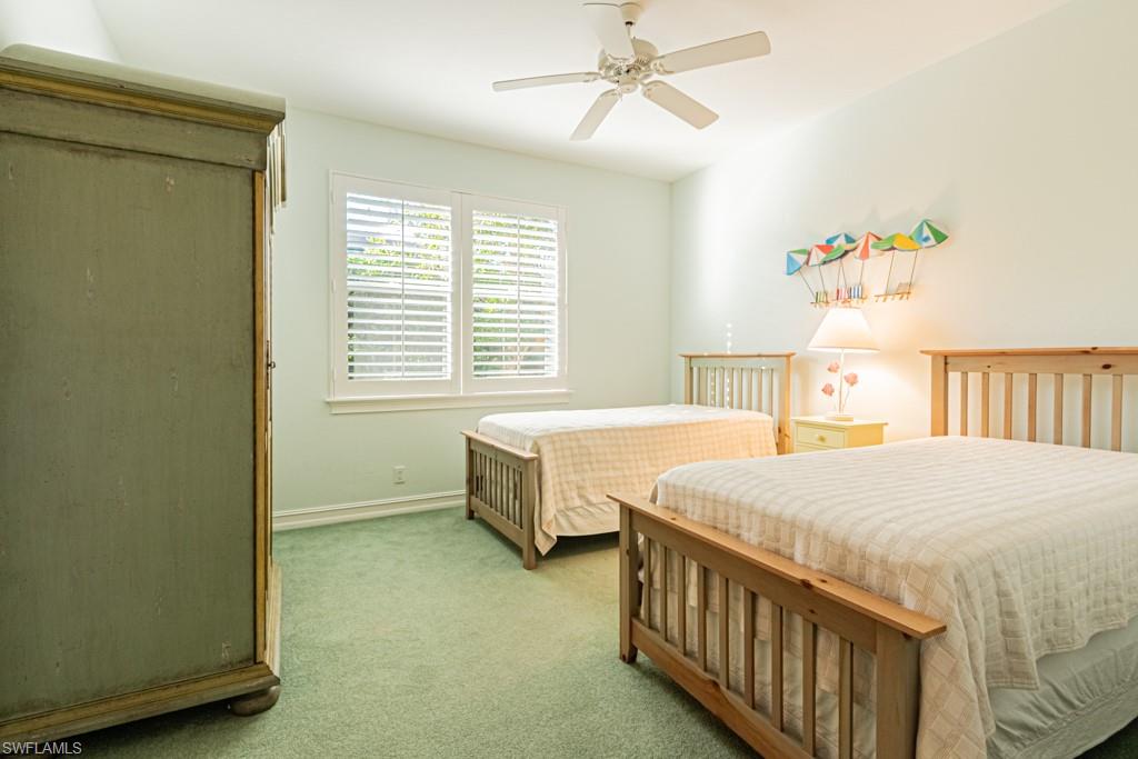 1676 Persimmon Drive Naples, FL 34109 - Photo 34 of 50 a bedroom with a bed and a window