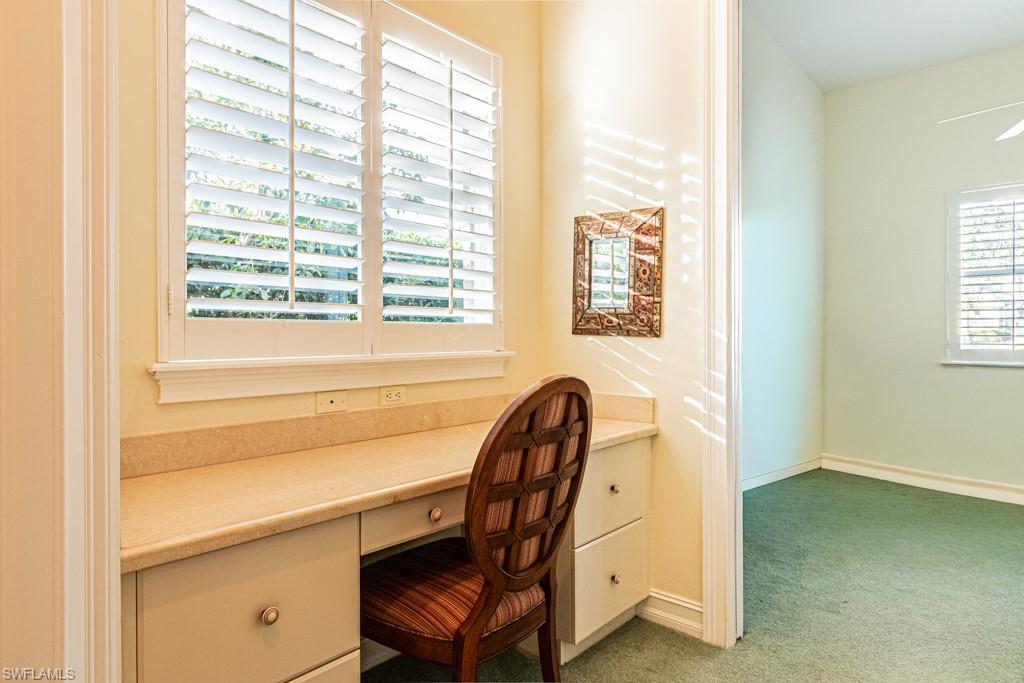 1676 Persimmon Drive Naples, FL 34109 - Photo 38 of 50 a view of a workspace with furniture and a window