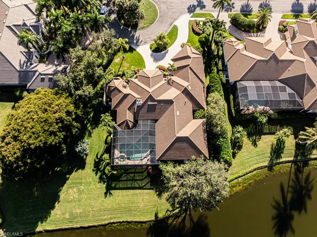 an aerial view of residential houses with outdoor space and ocean view