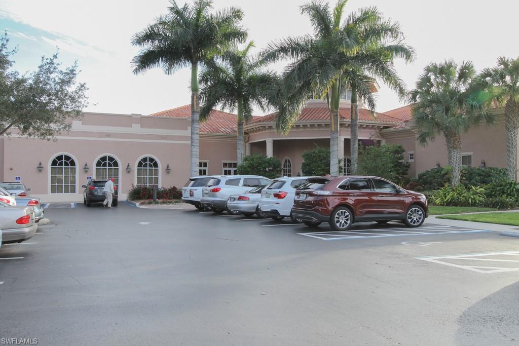 1676 Persimmon Drive Naples, FL 34109 - Photo 50 of 50 a car parked in front of a house and a car parked on the road