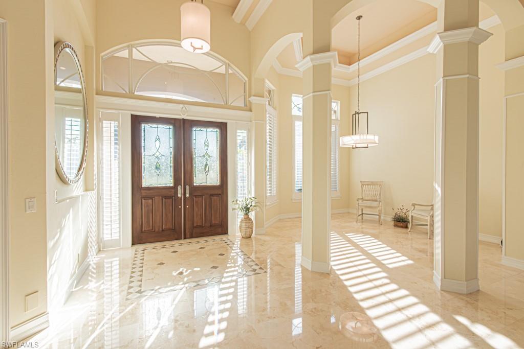 1676 Persimmon Drive Naples, FL 34109 - Photo 10 of 50 a bathroom with a glass shower door and a bathtub