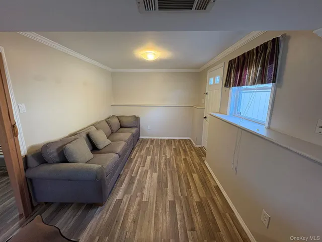 a living room with a couch and a book shelf