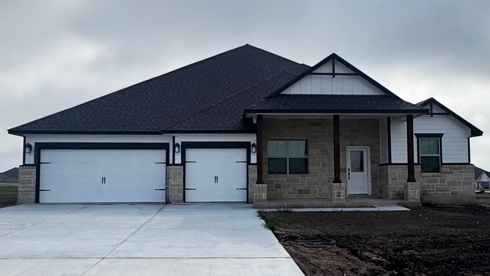 14537 Egon Road Salado, TX 76571 - Photo 2 of 27 View of front facade with a porch, an attached garage, driveway, stone siding, and a shingled roof