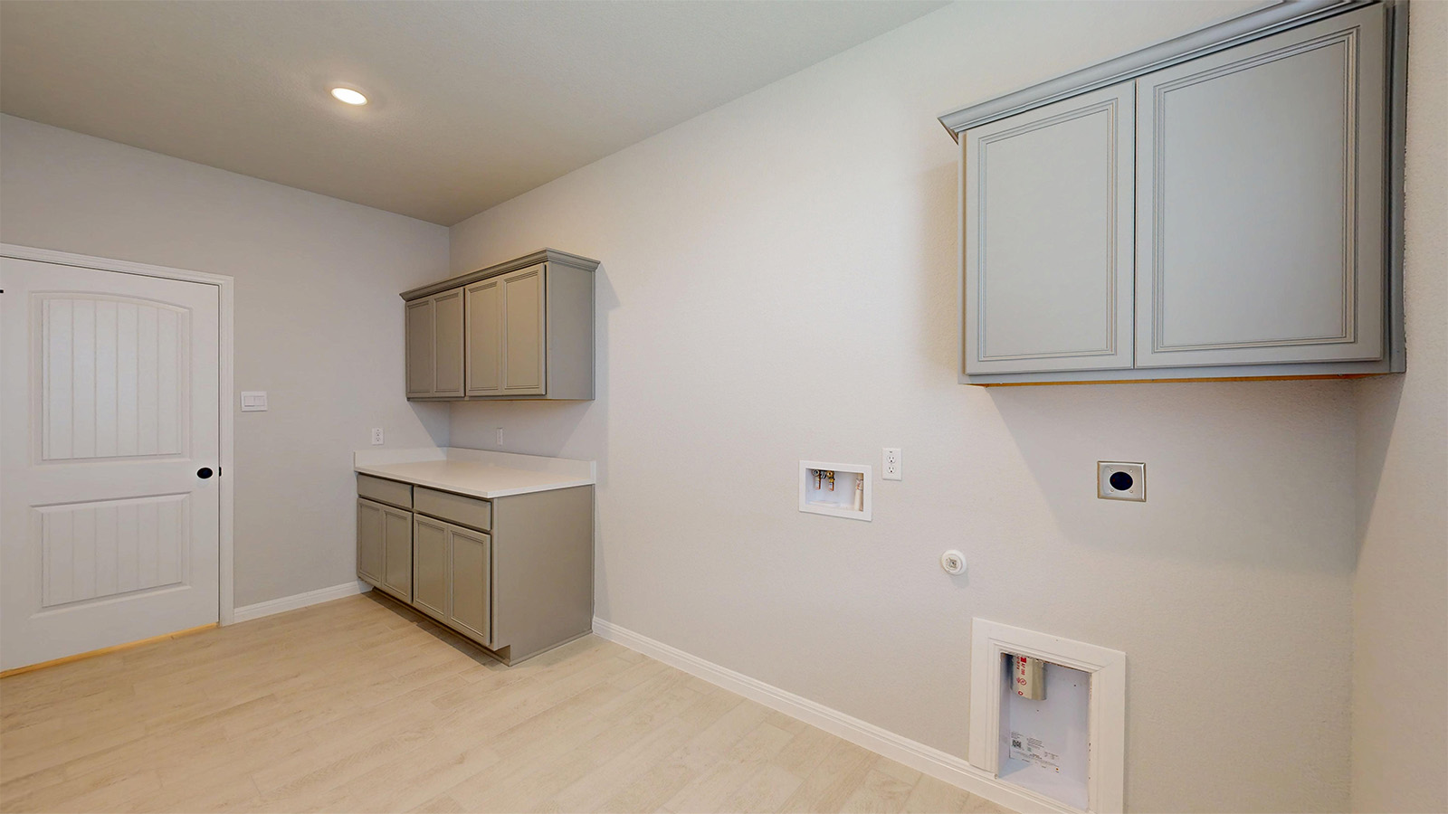14537 Egon Road Salado, TX 76571 - Photo 26 of 27 Laundry room featuring cabinet space, hookup for a gas dryer, light wood-type flooring, washer hookup, and electric dryer hookup
