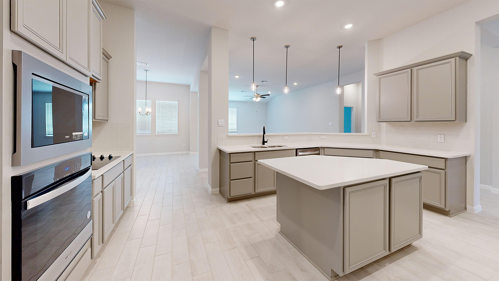 14537 Egon Road Salado, TX 76571 - Photo 6 of 27 Kitchen with light countertops, gray cabinets, a kitchen island, and stainless steel appliances