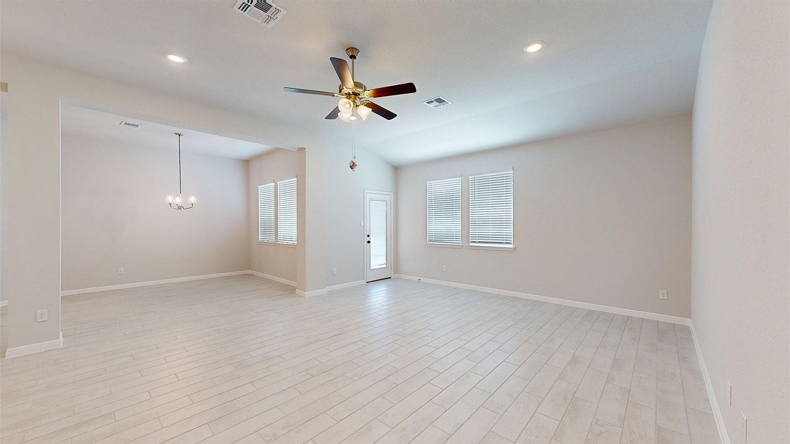 14537 Egon Road Salado, TX 76571 - Photo 7 of 27 Unfurnished room featuring ceiling fan, plenty of natural light, light wood finished floors, and suspended lighting