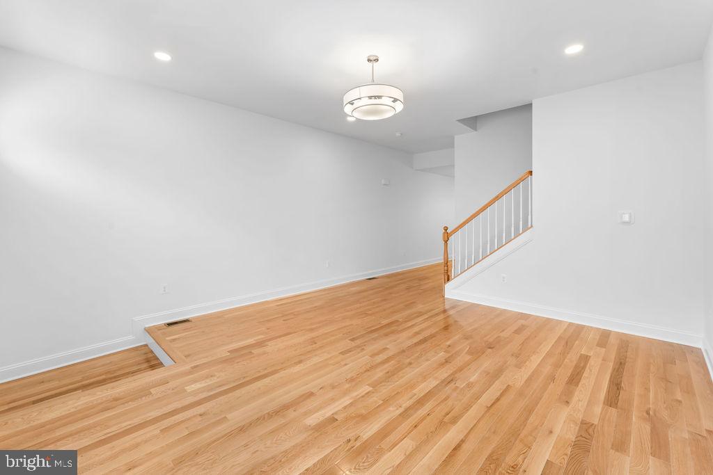40 South Fulton Avenue Baltimore, MD 21223 - Photo 4 of 42 a view of an empty room with wooden floor and a window