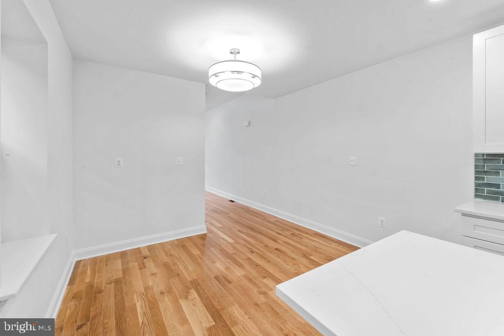 40 South Fulton Avenue Baltimore, MD 21223 - Photo 7 of 42 a view of empty room with wooden floor