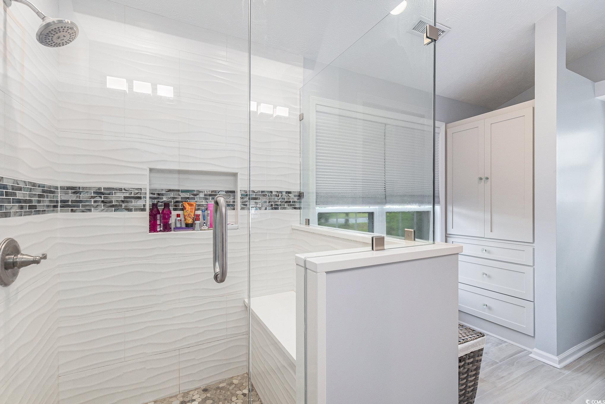 1105 Lampwick Lane Murrells Inlet, SC 29576 - Photo 23 of 40 Bathroom with a tile shower and lofted ceiling