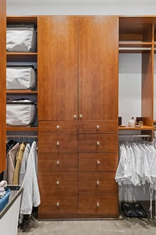 a view of walk in closet with clothes