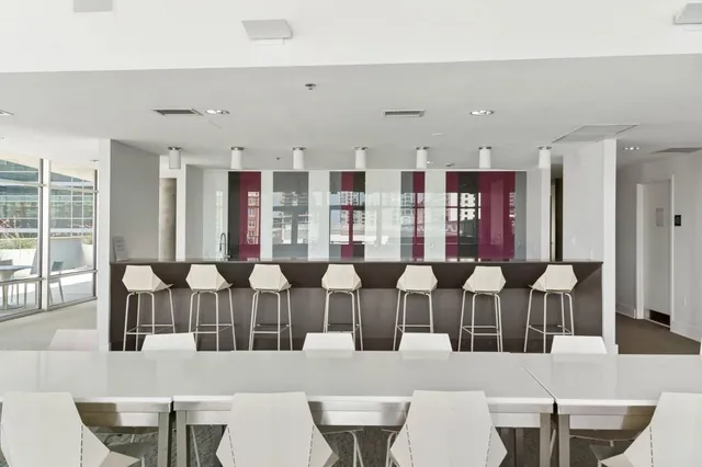 a large dining room with furniture and wooden floor