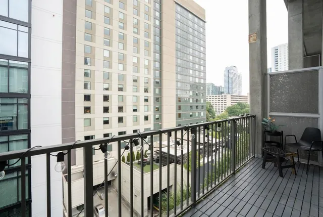 a view of balcony with furniture and wooden floor