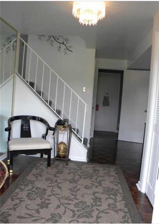 large entry way with double door coat closet.  Straight ahead you will find a full bath and the laundry room.  To the right, the gameroom w/woodburner.  To the left of the full bath/ laundry is a door leading down to oversized 2 car garage w/storage.  