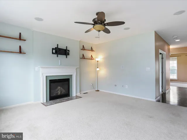 a view of empty room with a fireplace