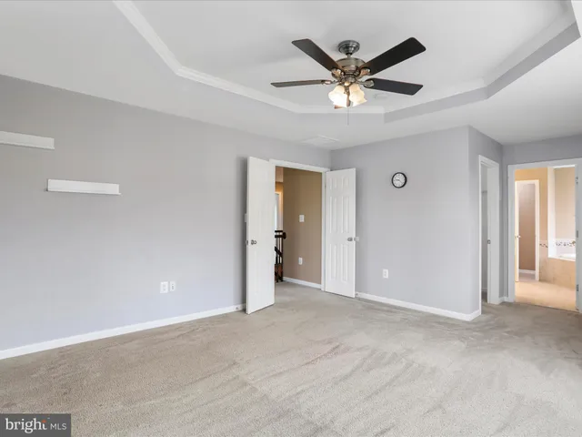 a view of an empty room with a ceiling fan