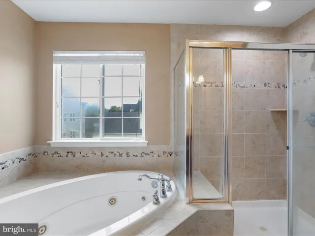 a bathroom with a bathtub and shower