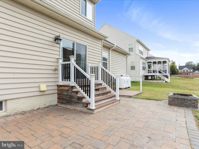 a view of a house with a backyard and a chair