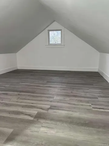 a view of a room with an empty space and wooden floor