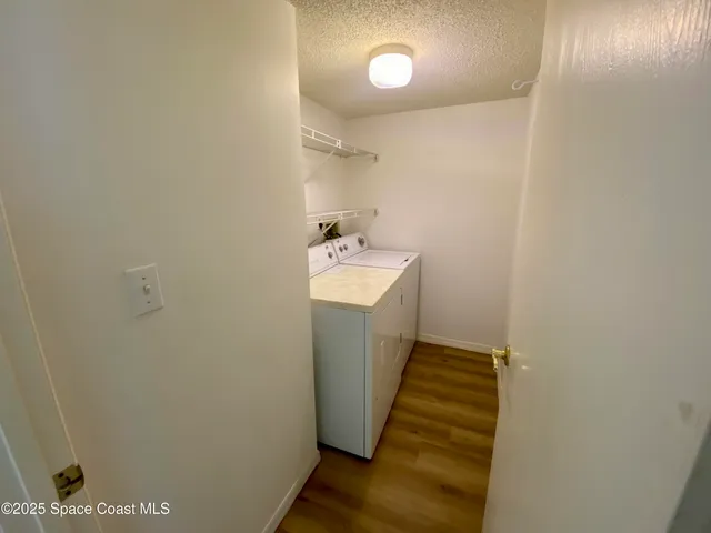 a view of a livingroom with wooden floor and a ceiling fan