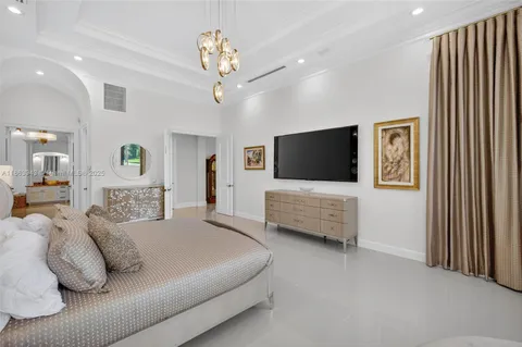 a living room with furniture a fireplace and a large window