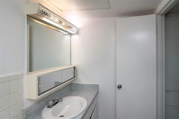 a bathroom with a sink and mirror