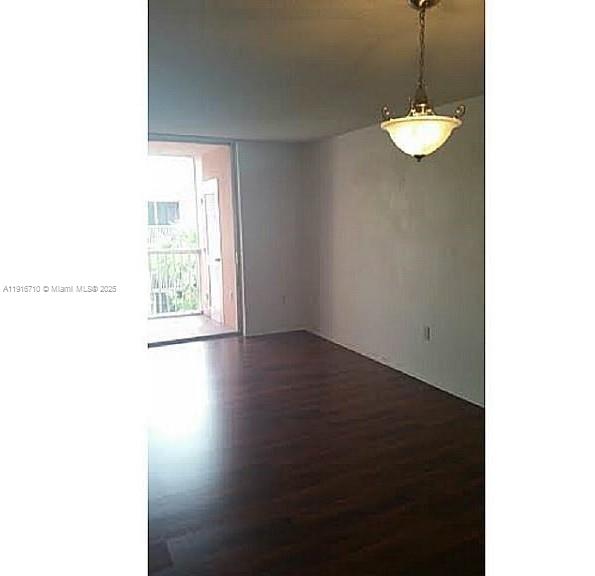19825 Southwest 114th Avenue, Unit 323 Miami, FL 33157 - Photo 18 of 22 a view of a room with wooden floor and chandelier