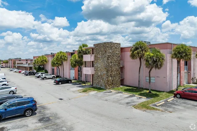 a row of cars parked in front of a house