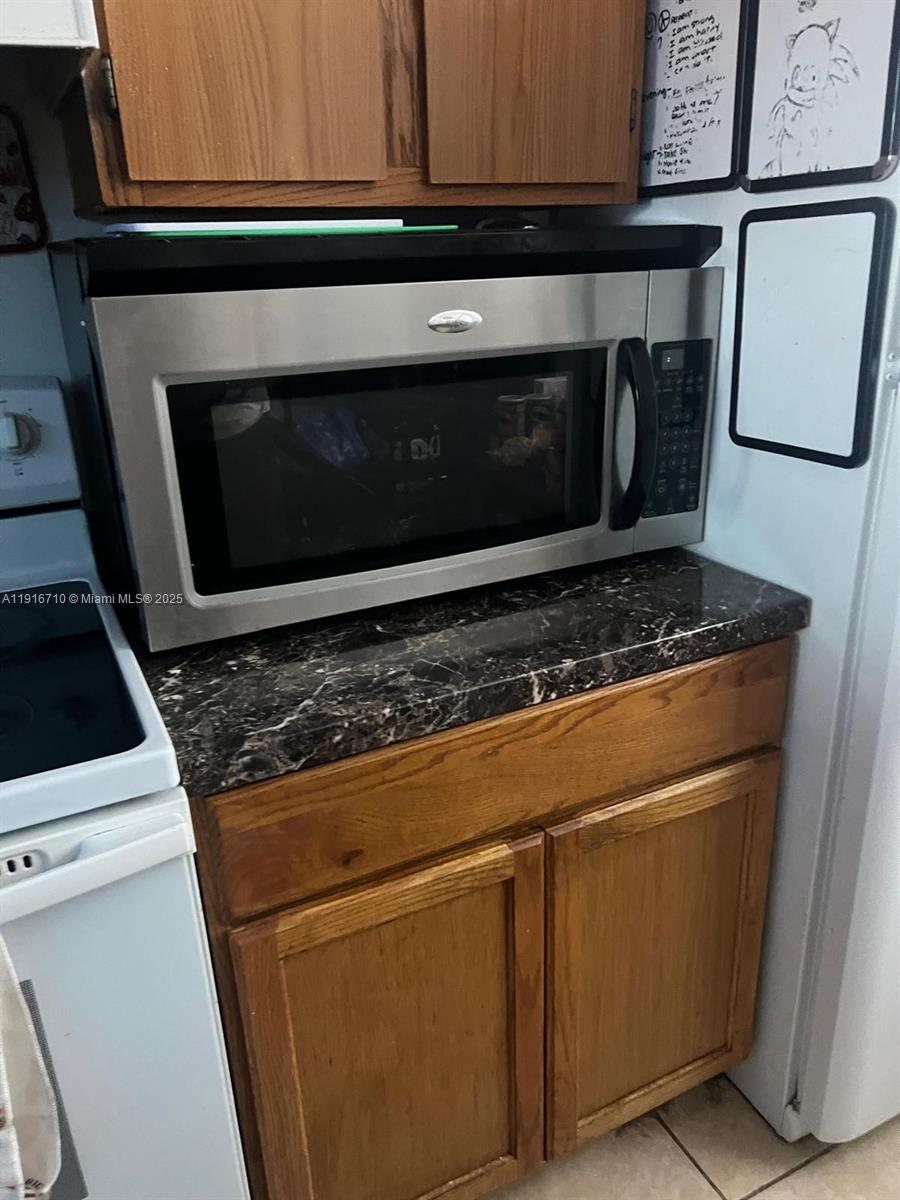 19825 Southwest 114th Avenue, Unit 323 Miami, FL 33157 - Photo 7 of 22 a stove top oven sitting inside of a kitchen