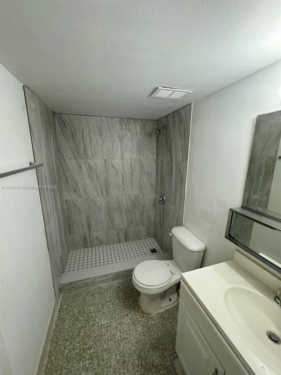 19825 Southwest 114th Avenue, Unit 323 Miami, FL 33157 - Photo 9 of 22 a bathroom with a sink a toilet and shower