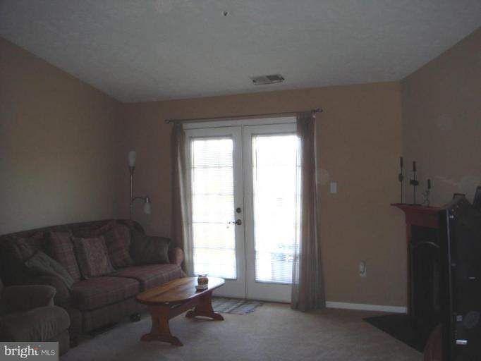 6470 Greenfield Road, Unit 1107 Elkridge, MD 21075 - Photo 7 of 7 vaulted ceiling, french doors to balcony, fireplac