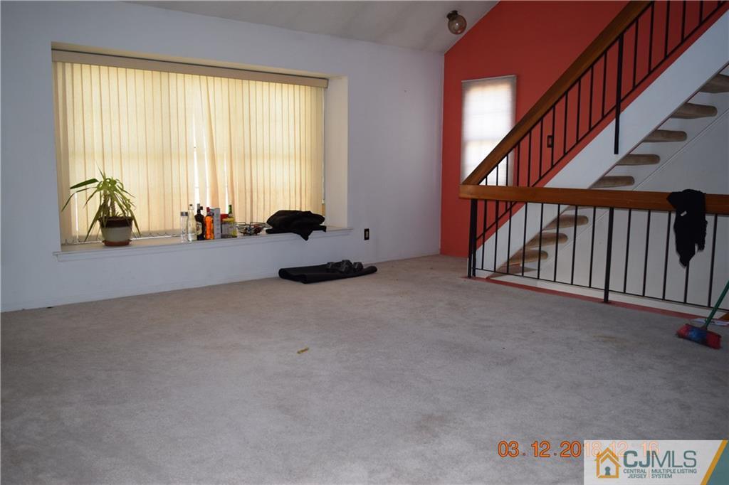 205 Commons Way, Unit 5 East Brunswick, NJ 08816 - Photo 3 of 10 a view of an empty room with a window